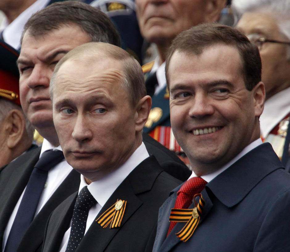 Russian President Vladimir Putin (C), Prime Minister Dmitry Medvedev (R) and acting Defence Minister Anatoly Serdyukov (L) watch the Victory Parade on Moscow's Red Square. Photo: REUTERS/Sergei Karpukhin.